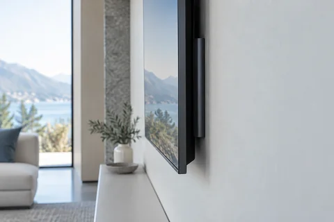 Illustrative a close side view of a professionally mounted display with concealed cabling against a pale wall